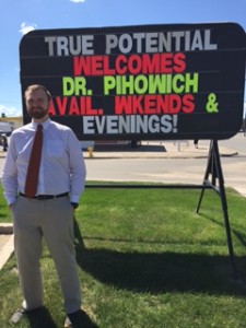 Dr Pihowich in front of Welcome Sign